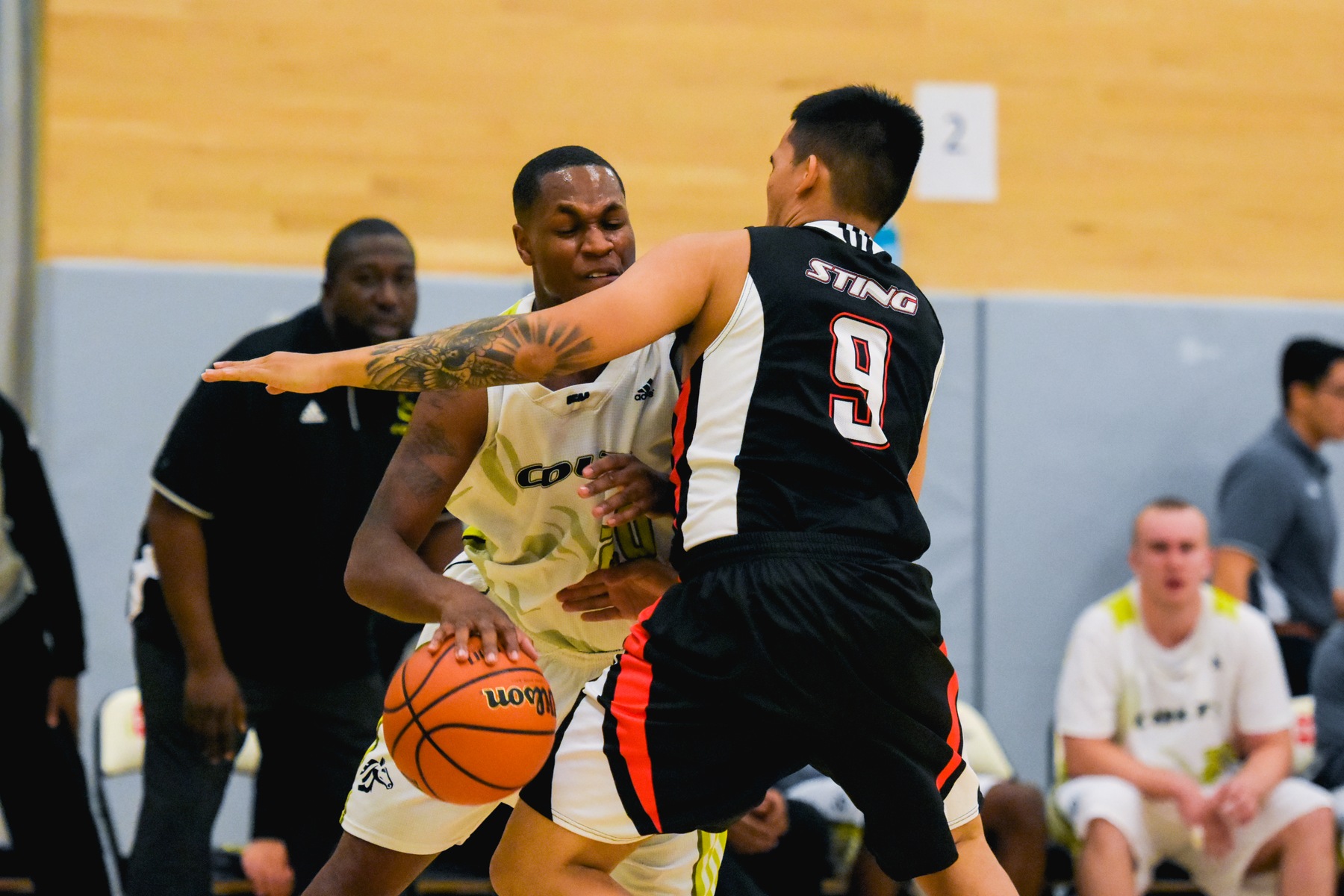 Centennial Colts' forward Paul Walwyn tries to get by a Seneca Sting defender in men's basketball action.