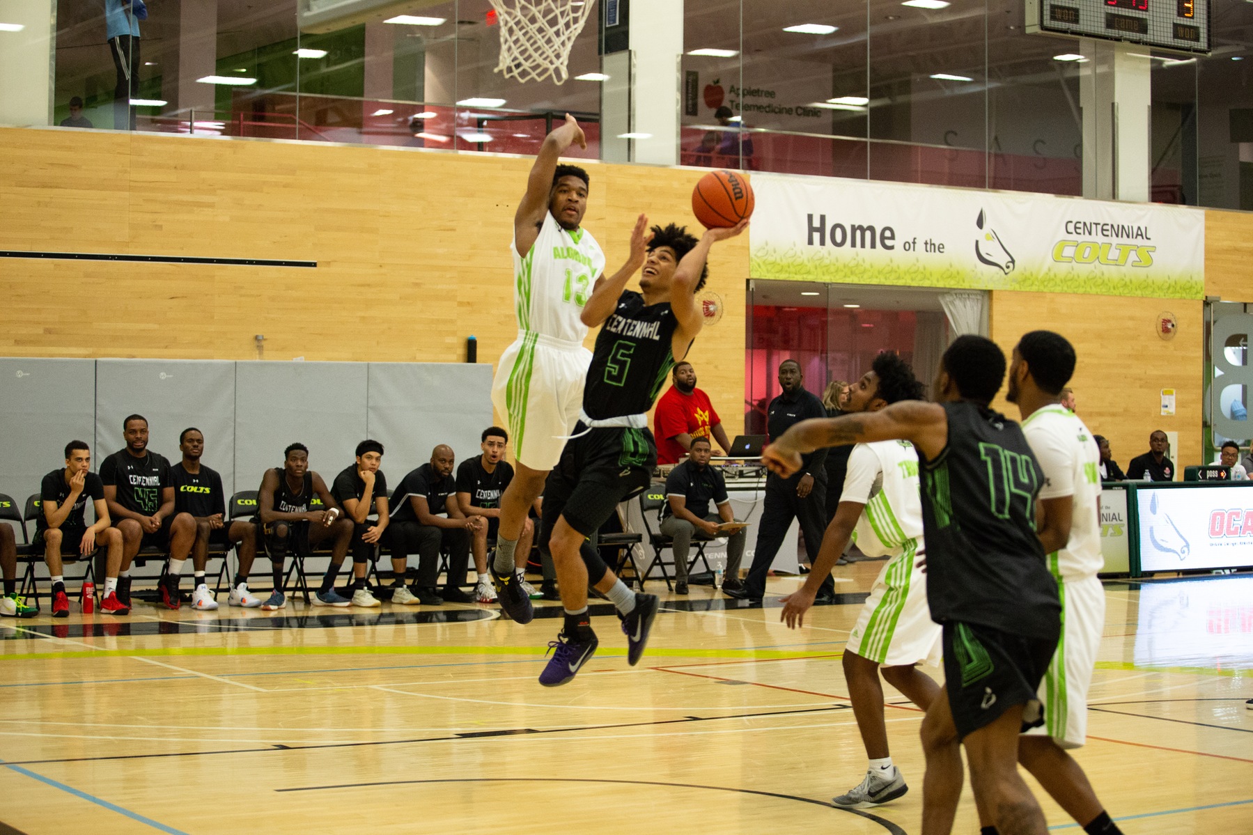 Isaiah Adeboboye of the Centennial Colts attacks the rim and lays it in past a lurking David Tshimanga of the Algonquin Thunder during second half action between the two teams. Centennial closed out 2018 with an impressive 86-69 win, snapping Algonquin's six-game winning streak. (Nicole Ventura/Colts Media)