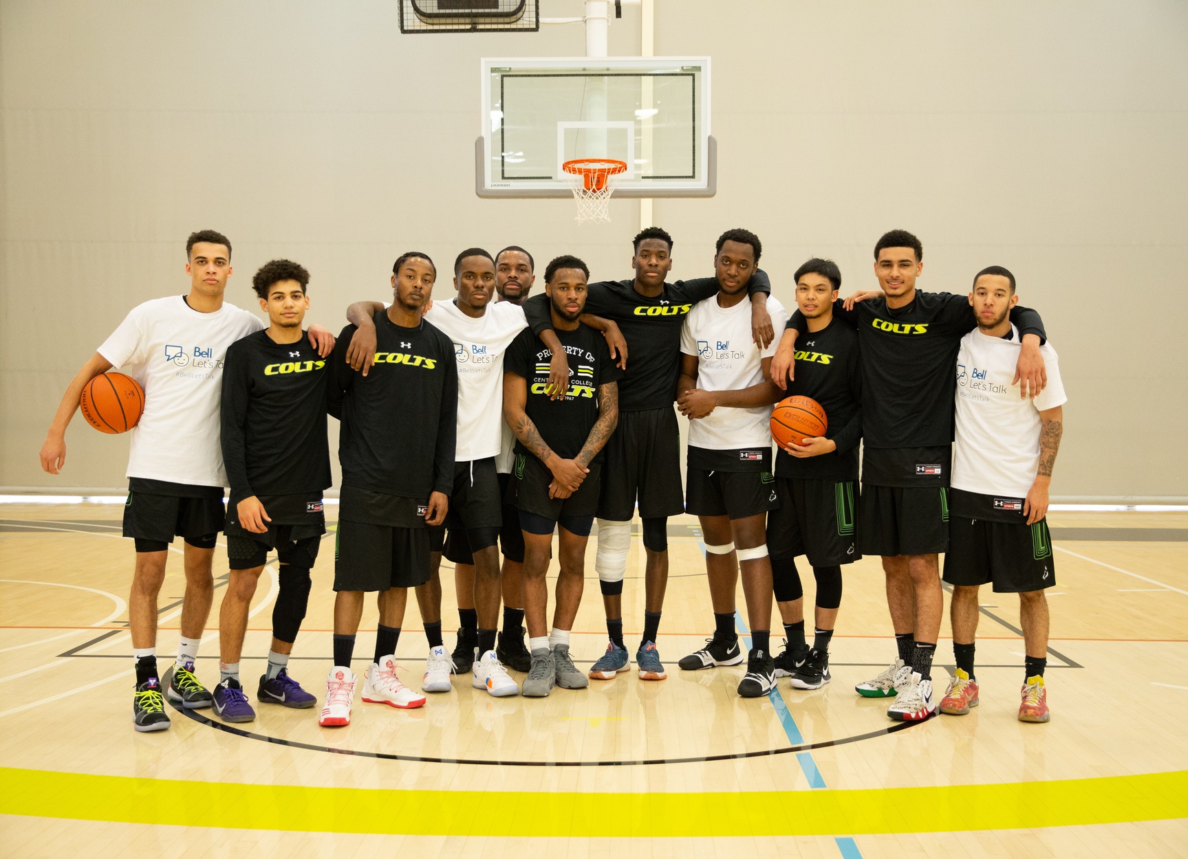 The Centennial Colts men's basketball team stands for a picture. Some of them wore Bell Let's Talk shirts in support of mental health. (Nicole Ventura/Colts Media)