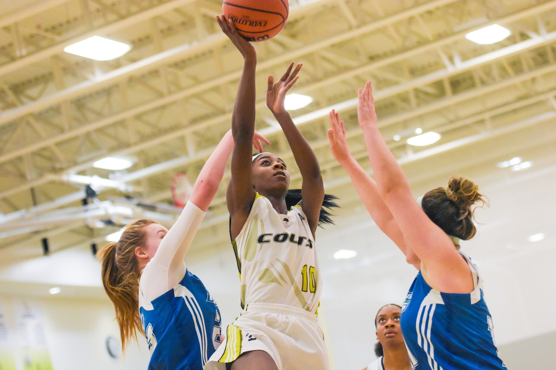 Centennial's Yasmeen Smith goes up for a layup against two George Brown defenders during Wednesday night's game at the Athletic and Wellness Centre. Although Smith finished with 33 points and 14 rebounds, the Colts fell to the top seeded Huskies, 96-77. (Yvano Antonio/Colts Athletics)